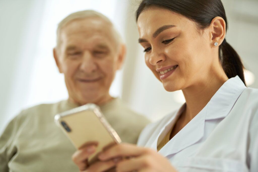 smiling-nurse-and-senior-citizen-with-phone